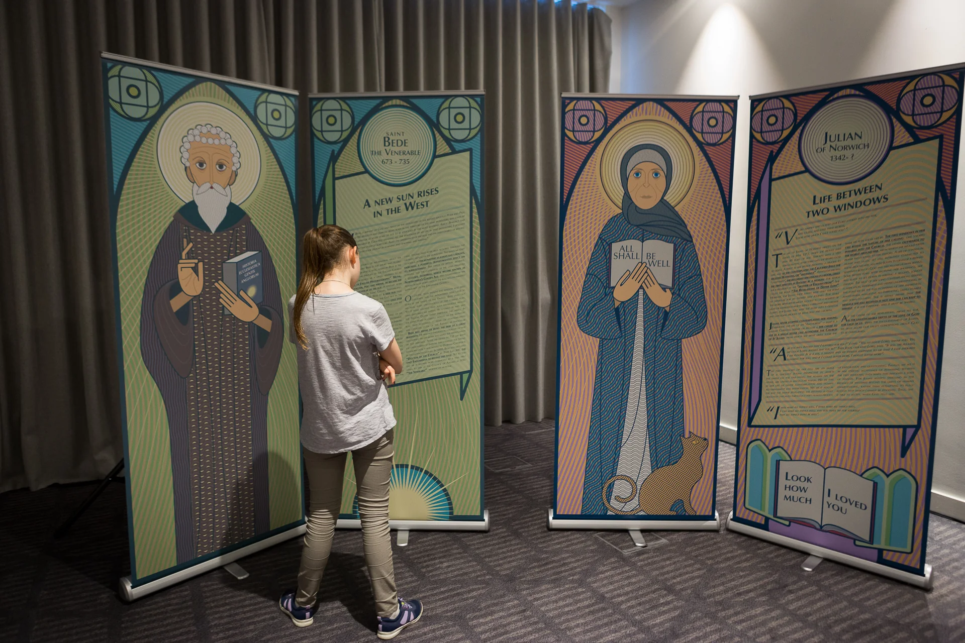 A visitor reading a Holy Unexpected text panel